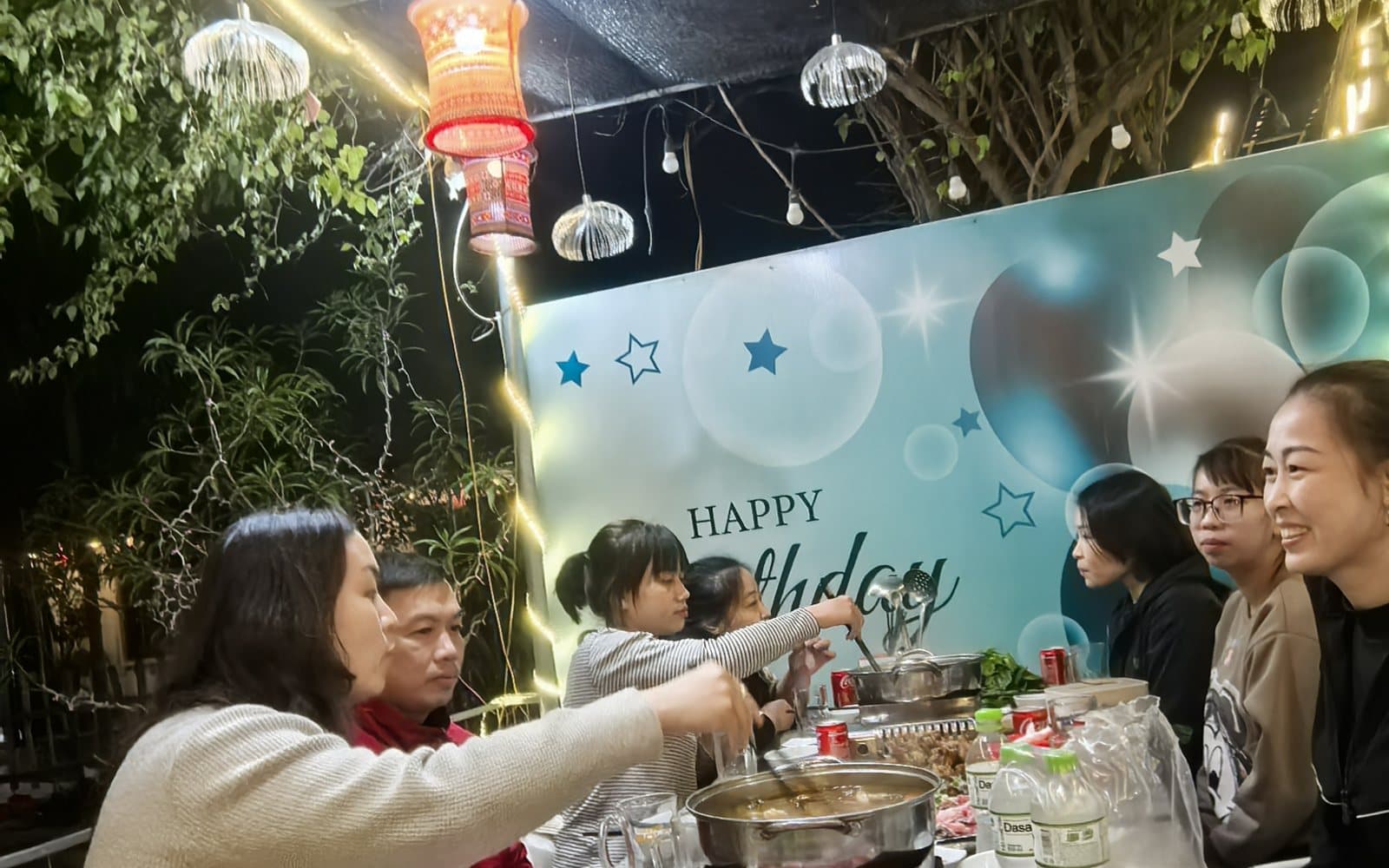 Colleagues from BURTONO's Vietnam production base sharing a team dinner