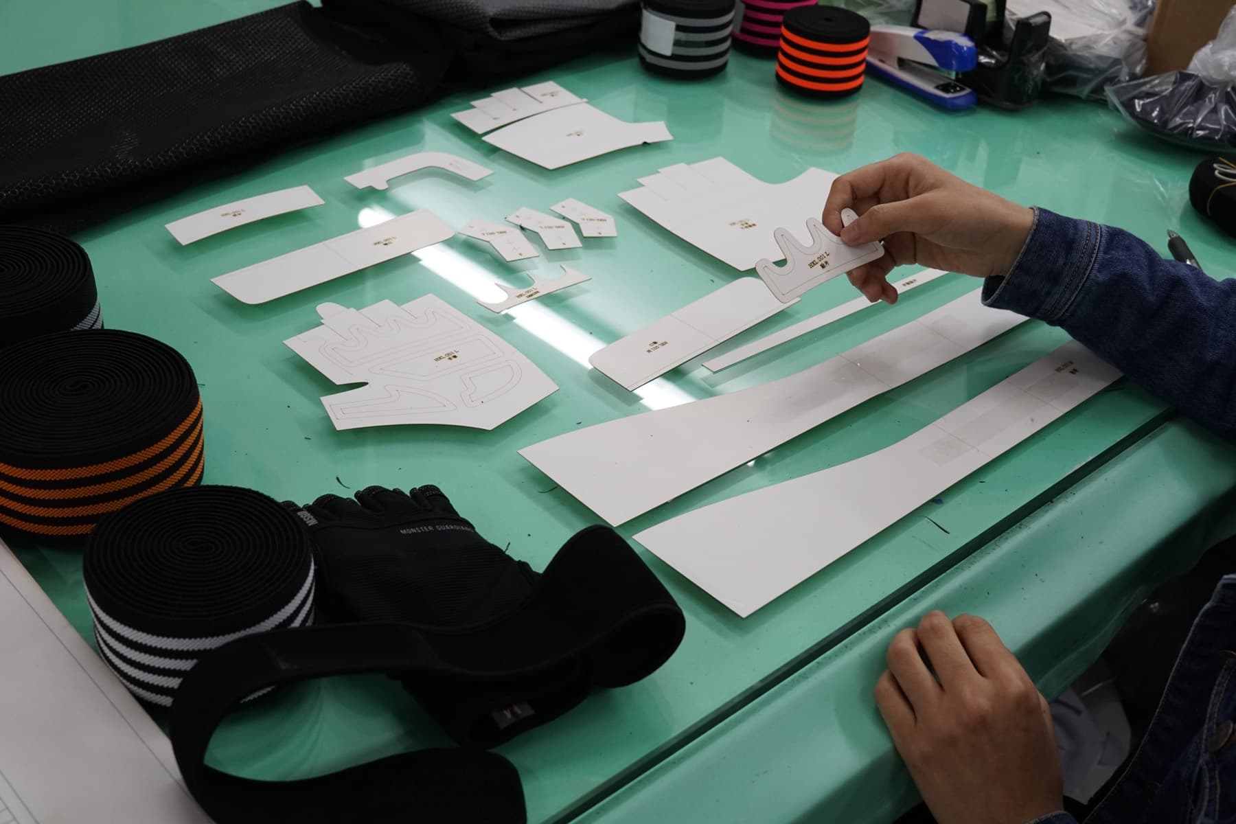 BURTONO developer checking a sports glove construction sheet during sample development