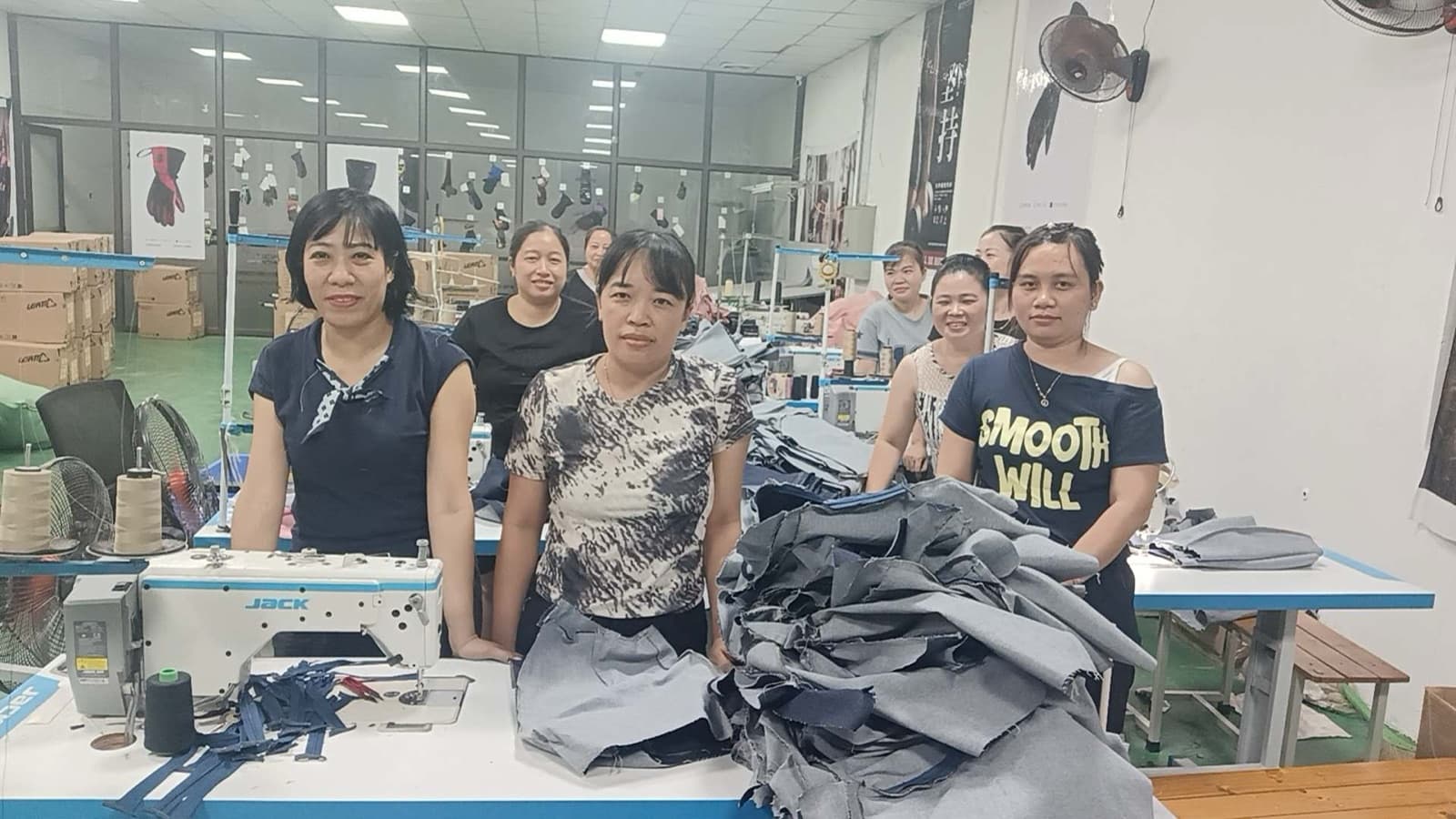 Production workers beside sewing machines at BURTONO's Vietnam base