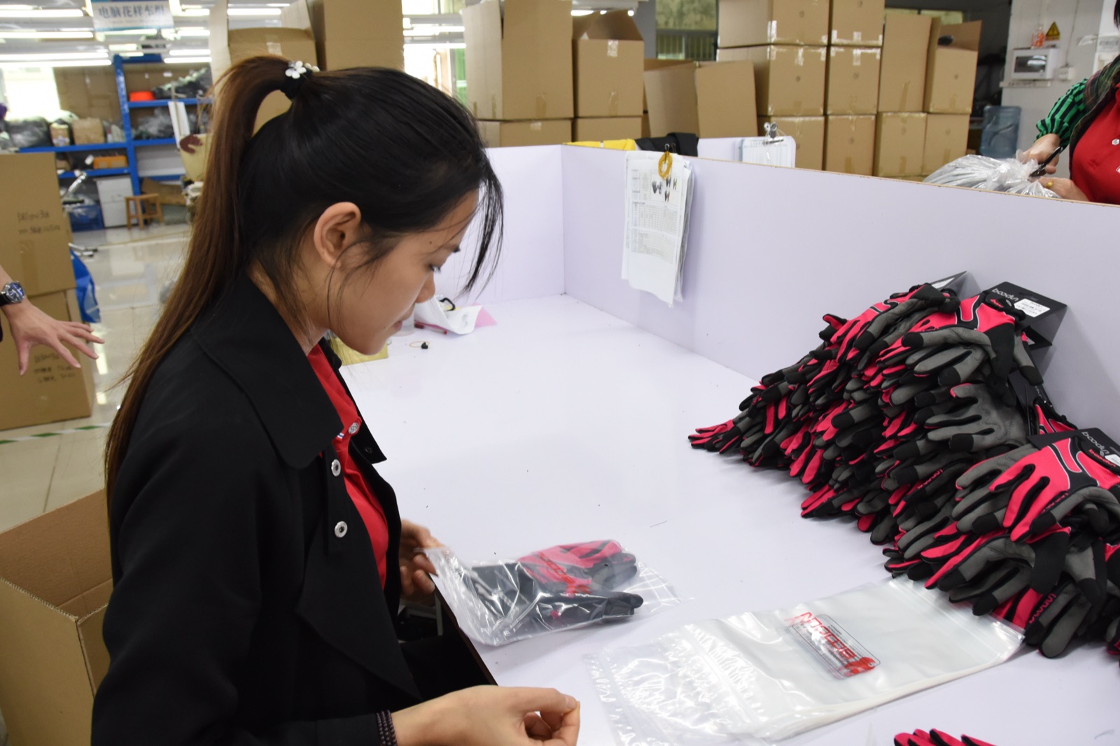 BURTONO team checking finished sports gloves before packing