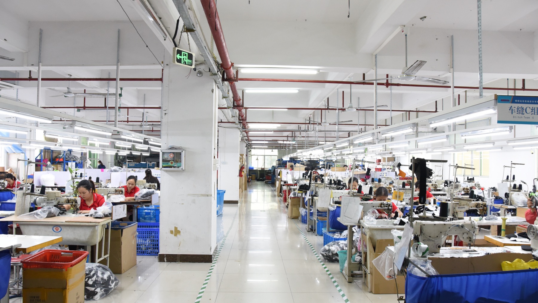 BURTONO sports glove factory workshop with sewing stations and production staff